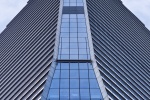 A colorful architectural photo of the facade of 10 Hudson Yards in New York City seen from an upward-looking perspective. Large-scale framed prints of this photo are available up to 80 inches in height.