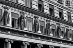 A black and white architectural photo of the neoclassical facade of 100 Broadway in New York City's Financial District