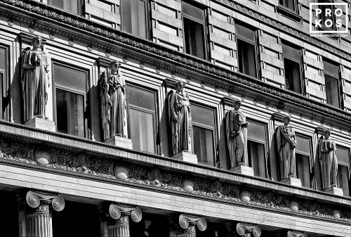 A black and white architectural photo of the neoclassical facade of 100 Broadway in New York City's Financial District