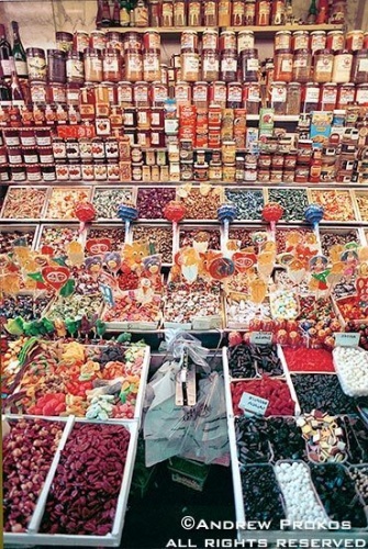 A candy stand in Barcelona's famous Boqueria Market.  Fine art prints of this photo are available framed in various styles. 