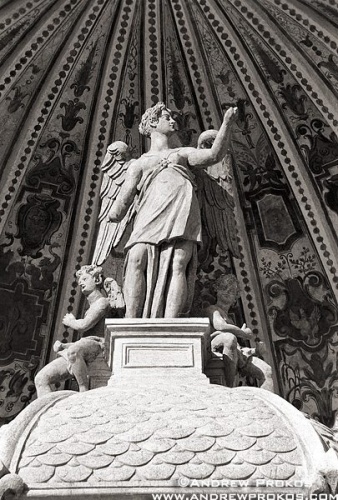 A black and white architectural detail of the winged statue atop the Organ Fountain in the gardens of the Villa D'Este, Tivoli, Italy. Fine art prints of this photo are available framed in various styles, please inquire.