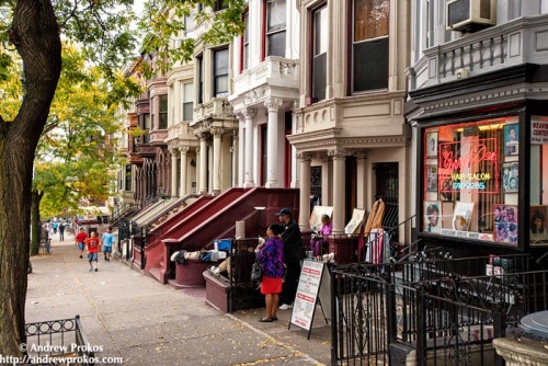 A street scene showing 145th Street in Harlem, NYC. Framed fine art prints of this photo are available in various sizes. 