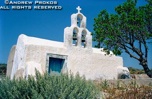 A rustic whitewashed chapel with campanile in the interior of the island of Santorini, Greece