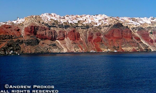 A view of the colorful cliffs of Santorini, Greece and its main town Thira from the sea