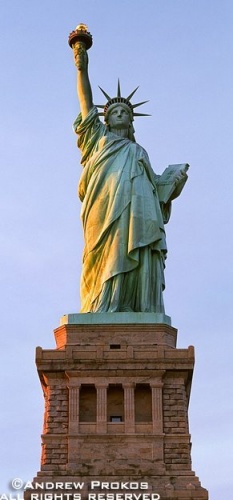 A panoramic photo of the Statue of Liberty at sunset, New York City
