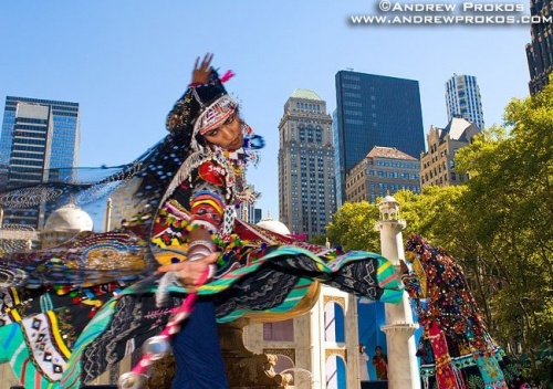 An Indian folk dancer in traditional costume takes a whirl in Bryant Park, New York City