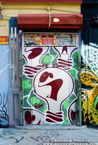 A door painted with graffiti as part of a street mural in New York City. Framed fine art prints of this photo are available in various sizes. 