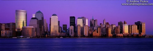 A panoramic skyline of Lower Manhattan at dusk as seen from New Jersey