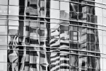 A black and white fine art photograph of the abstracted reflections on a yellow glass facade in Abu Dhabi, United Arab Emirates. Limited edition prints of this photo are available up to 96 inches in height and framed in various contemporary styles. 