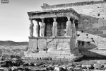 A black and white fine art photograph of the Porch of the Caryatids from the Erechtheion, show in situ on the Acropolis in Athens, Greece