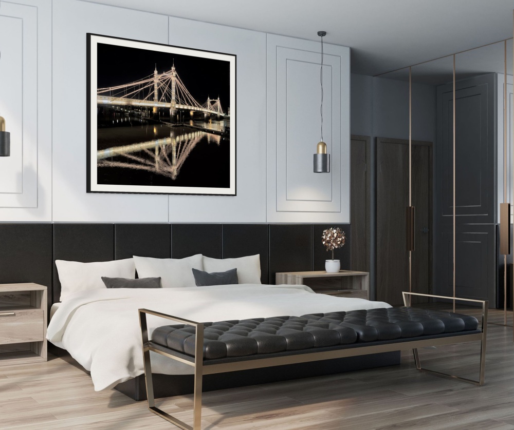 A framed architectural photo of the Albert Bridge in London at night as seen in an upscale loft interior. Fine art prints of this photo are available up to 72 inches and framed in contemporary styles. 
