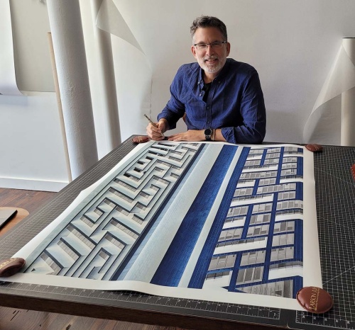 Photographer Andrew Prokos signing a large-format limited edition print from his award-winning series Inverted