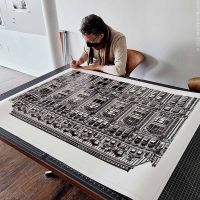 Photographer Andrew Prokos signing a 50 inch black and white limited edition architectural print. New York City December 2021.