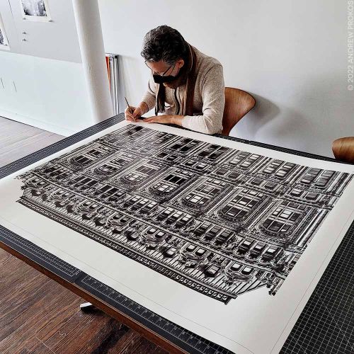Photographer Andrew Prokos signing a 50 inch black and white limited edition architectural print. New York City December 2021.