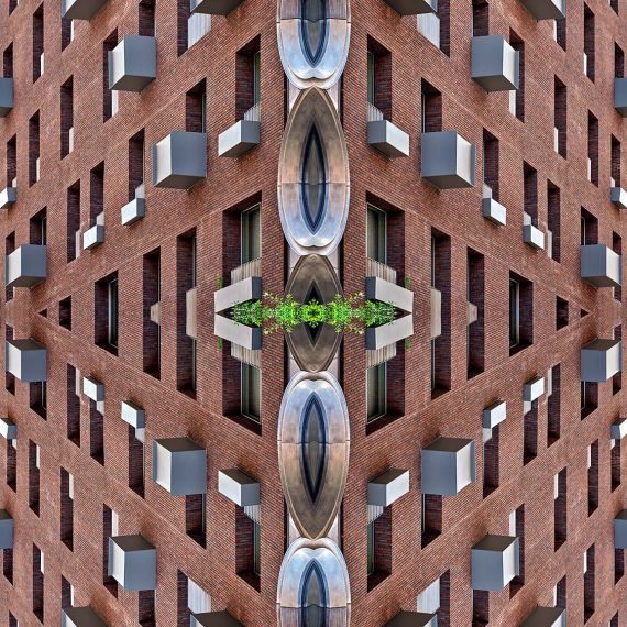 A photograph capturing the repeated shapes and patterns of a brick architectural facade in New York City in tones of brick and metallic grey. Large-scale limited edition prints of this photo are available up to 80 inches.