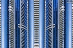 An abstract photograph composed of reflected views of contemporary blue glass tower facades in Dubai, UAE from Andrew's series Archistracts. Large-scale limited edition prints of this photo are available up to 96 inches in width.