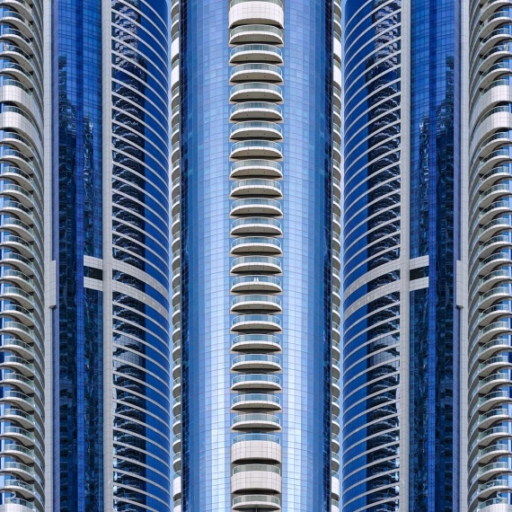 An abstract photograph composed of reflected views of contemporary blue glass tower facades in Dubai, UAE from Andrew's series Archistracts. Large-scale limited edition prints of this photo are available up to 96 inches in width.