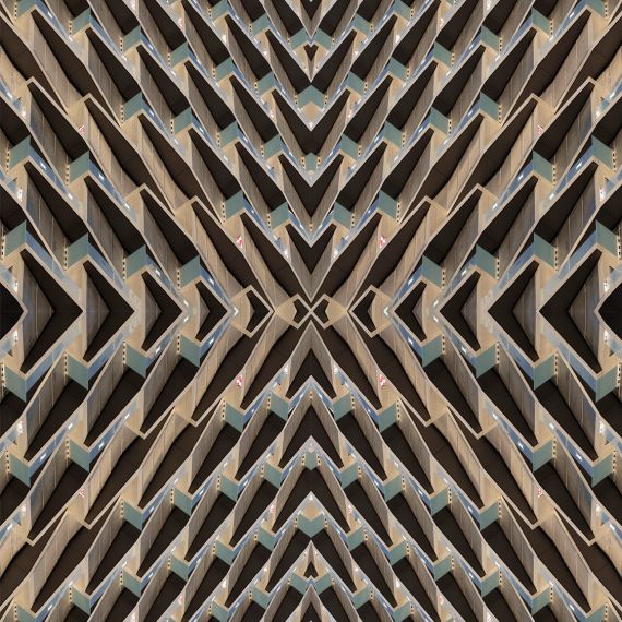 A geometric abstract photograph capturing the angular patterns derived from architecture in tones of green and gold. Large-scale limited edition prints of this photo are available up to 120 inches in height.