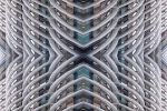 A large-scale abstract photograph composed of reflected patterns from an undulating architectural facade in tones of white, grey, gold, with pops of aqua. Large-scale limited edition prints of this photo are available up to 120 inches in height.