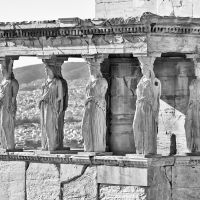 A black and white photograph of the famed caryatids from the Porch of the Maidens in the Erechtheion on the Acropolis in Athens, Greece