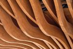 A close-up architectural detail of the curved wood beams forming the 'tree' structure enveloping the facade of the Azerbaijan Pavilion at the Dubai World Expo. Large-scale fine art prints of this photo are available up to 60 inches.