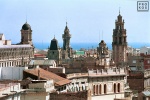 A multitude of spires and rooftops in Barcelona looking toward the sea. Fine art prints of this photo are available framed in various styles, please inquire. 