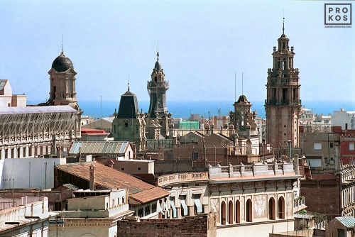A multitude of spires and rooftops in Barcelona looking toward the sea. Fine art prints of this photo are available framed in various styles, please inquire. 