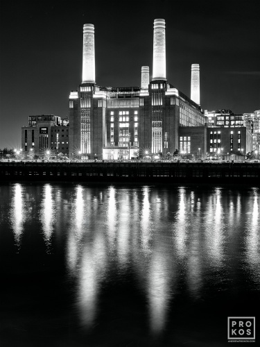 A black and white fine art photo of Battersea Power Station and lights reflected on the Thames River at night, London, United Kingdom. High-definition fine art prints of this photo are available up to 80 inches in height.