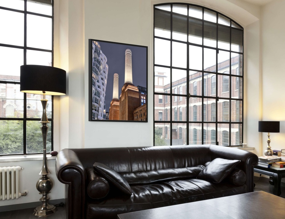 A framed architectural photo of Battersea Power Station in London as seen in an upscale loft interior. Fine art prints of this photo are available up to 72 inches and framed in contemporary styles. 