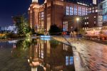 A view of Battersea Power Station reflected in a decorative pool at night, London, United Kingdom. High-definition fine art prints of this photo are available up to 72 inches in height.