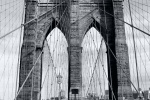 A black and white fine art photo of the Brooklyn Bridge tower and cables