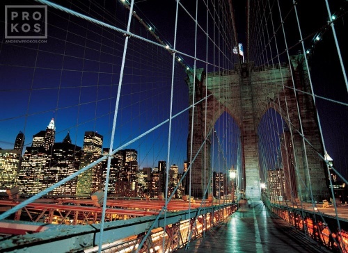 A color cityscape photo of the tower and suspension cables of the Brooklyn Bridge at night, New York City. Fine art prints of this photo are available framed in various styles. 