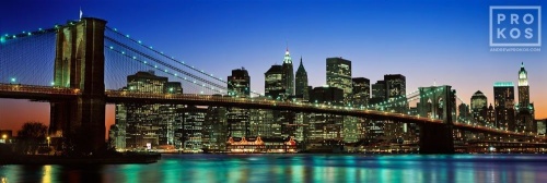 A high-definition panoramic skyline of the Brooklyn Bridge and Lower Manhattan at dusk, New York City