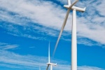 A landscape photo of a row of wind turbines in motion at the Biglow Canyon, Oregon wind farm