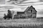 A black and white landscape photo of an abandoned farmhouse found in Biglow Canyon, Oregon.