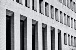 A black and white architectural photo of a modern linear building facade on the MIT campus in Cambridge, Massachusetts.