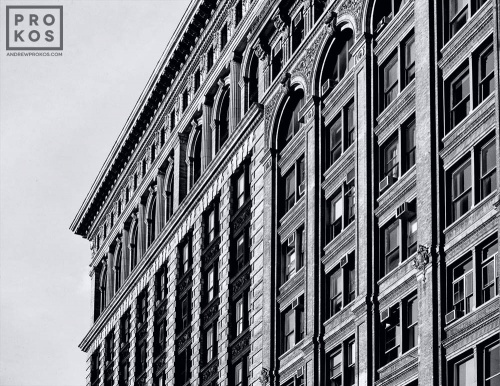 An architectural photo of the facades of the buildings along Broadway in Downtown Manhattan in black and white. Framed fine art prints of this photo are available in various sizes and styles. 