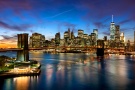 A panoramic view of the Brooklyn Bridge and the Lower Manhattan skyline at dusk, New York City