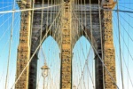 A high-definition fine art photograph of the Brooklyn Bridge's tower and suspension cables in color. Fine art prints of this photo are available framed in various wood, metal and acrylic styles. 