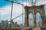 A high-definition panoramic photo of the Brooklyn Bridge's suspension cables and Lower Manhattan skyline, New York City