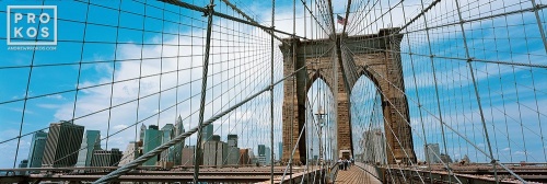 A high-definition panoramic photo of the Brooklyn Bridge's suspension cables and Lower Manhattan skyline, New York City
