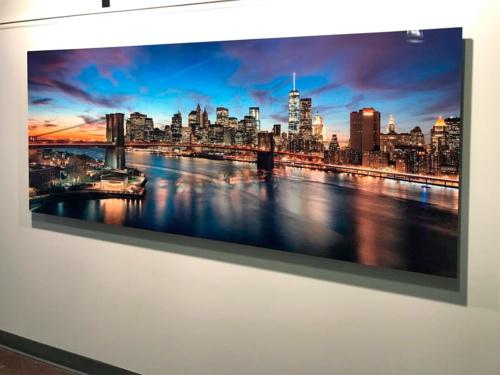 An 80 inch limited edition HD metal print of "Brooklyn Bridge and Lower Manhattan Skyline at Dusk" by photographer Andrew Prokos