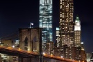 An ultra high-definition long-exposure photo of the Brooklyn Bridge and the skyscrapers of Lower Manhattan, World Trade Center, and 8 Spruce Street at night.