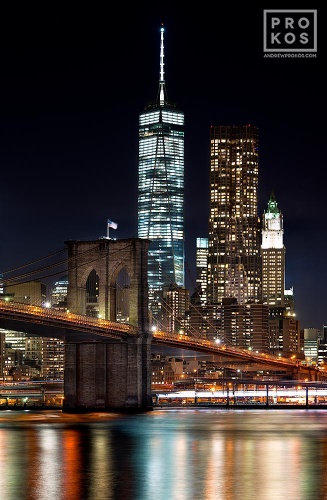 An ultra high-definition long-exposure photo of the Brooklyn Bridge and the skyscrapers of Lower Manhattan, World Trade Center, and 8 Spruce Street at night.