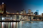 An ultra-high-definition panoramic skyline photo of the Brooklyn Bridge and Manhattan transitioning from day to night, from Andrew's 'Night & Day' series.