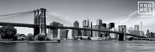 A panoramic skyline of the Brooklyn Bridge and Lower Manhattan in black and white, New York City