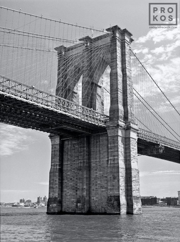 A fine art architectural photo of the Manhattan side tower of the Brooklyn Bridge in black and white, New York City. Fine art prints of this photo are available framed in various styles, please inquire. 
