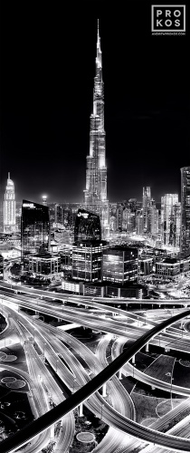 A vertical panoramic cityscape photo of the Burj Khalifa tower and Dubai as seen at night in black and white, United Arab Emirates. Limited edition fine art prints of this photo are available up to 96 inches in height.