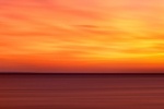 A large-format panoramic seascape photo of Cape Cod, Massachussetts at sunset.