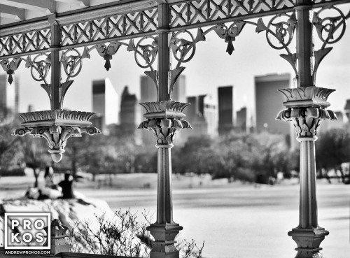 A black and white view of the frozen lake and Midtown skyline from the cast-iron gazebo in Central Park in Winter. Fine art prints of this photo are available for purchase framed in various styles.